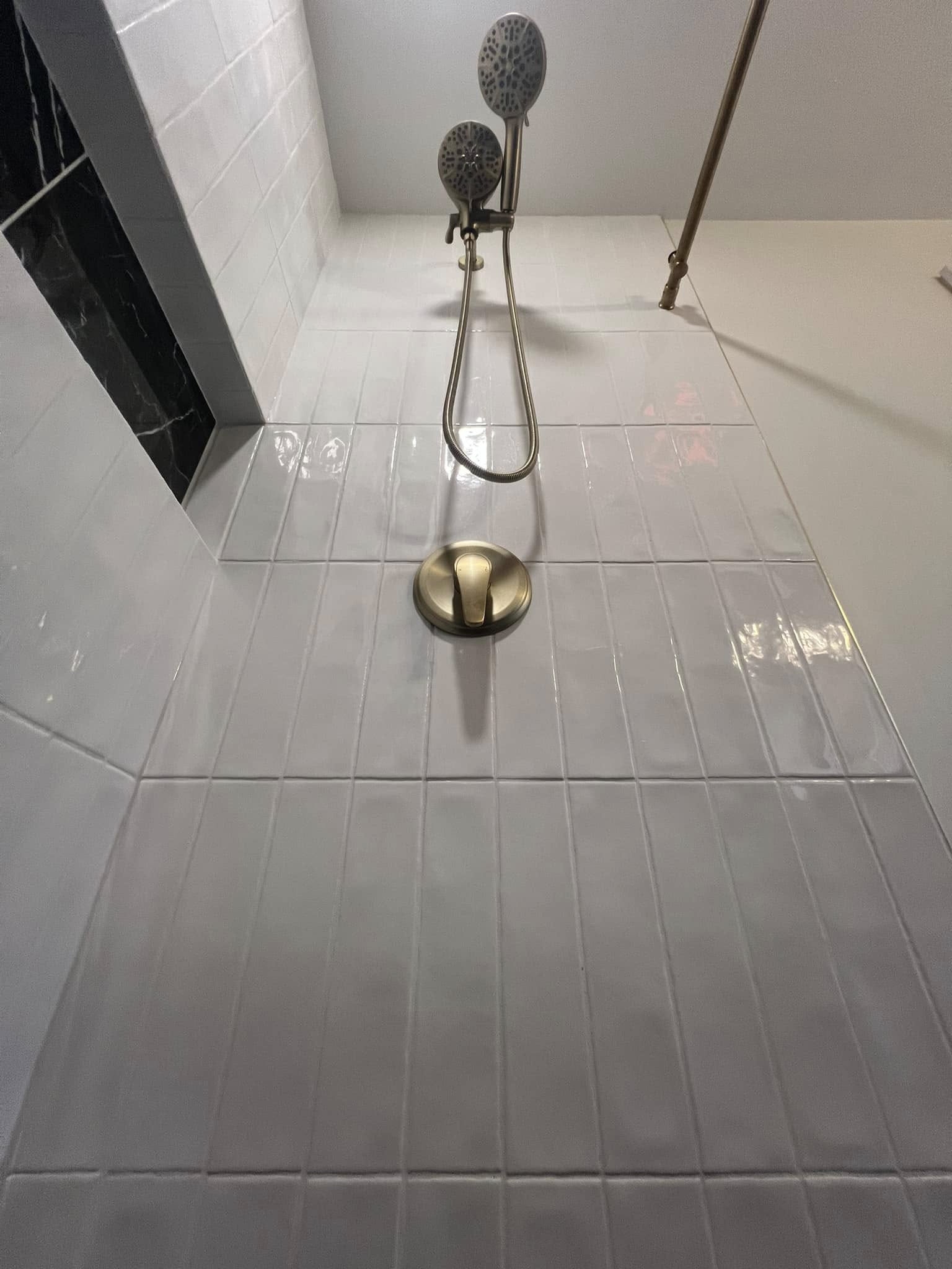 White subway tile shower with brass hardware